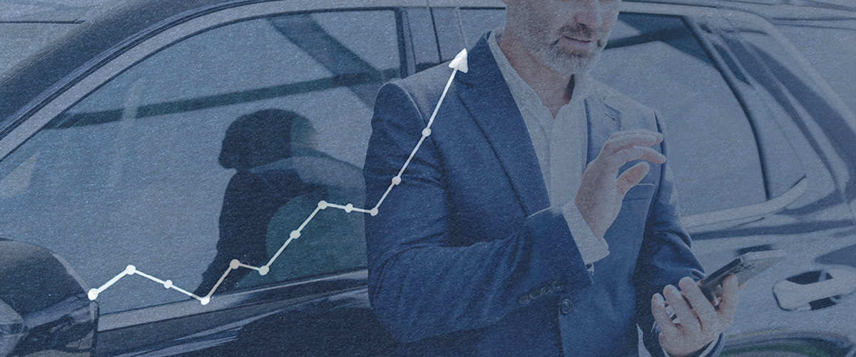 salesman leaning on car using his smart phone to look up prospects on map, overlaid with a chart pointing upwards to represent more sales